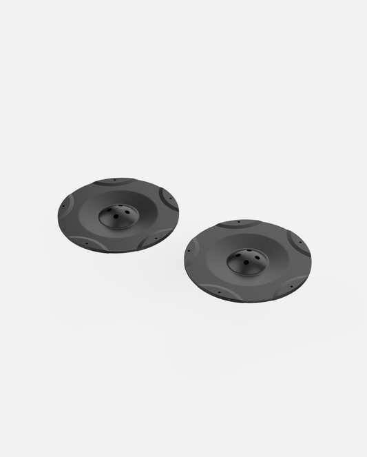 Two black cutting discs with central bolt holes and raised edges, Y Series lawn mower pro module replacement parts, side view on white background