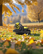 Black and yellow robotic leaf blower by Yarbo on grass with falling autumn leaves, side view