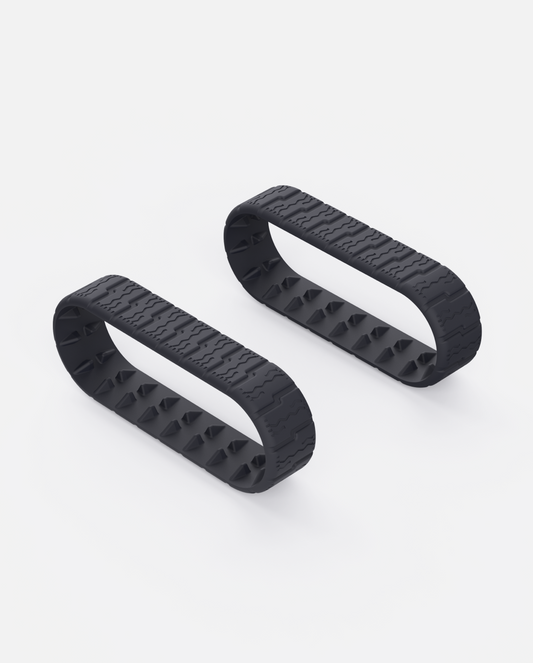 Black rubber Lawn Track (Y Series) with zigzag tread and spiked inner surface, shown in side view on white background