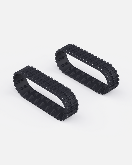 Black rubber snow tracks with aggressive tread pattern and metal studs, shown in side view on white background
